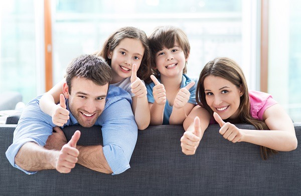 Family at home with thumbs up - Killingsworth Pest Control in Charlotte NC